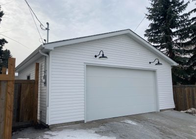 White garage with gooseneck lights